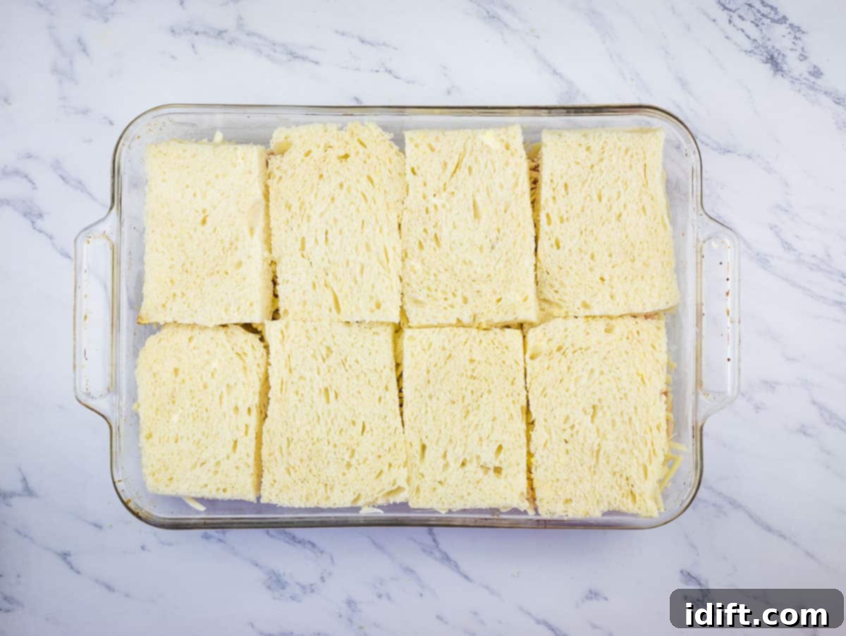 The final layer of bread placed on top of the casserole.