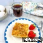Christmas Morning Casserole on a plate with strawberries.