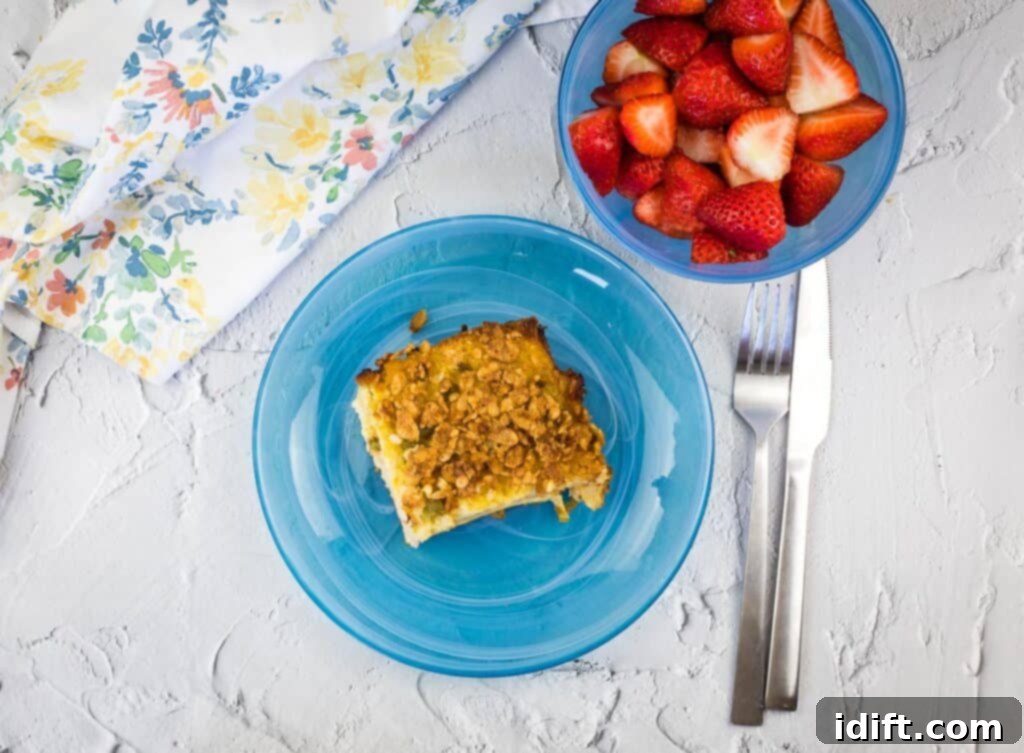 A top-down shot of a golden-brown Christmas Morning Casserole on a blue plate, ready to be served.