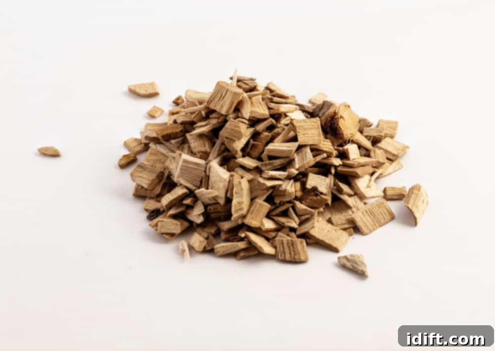 A small, neat pile of various wood chips, perfect for infusing food with diverse smoky flavors in an electric smoker.