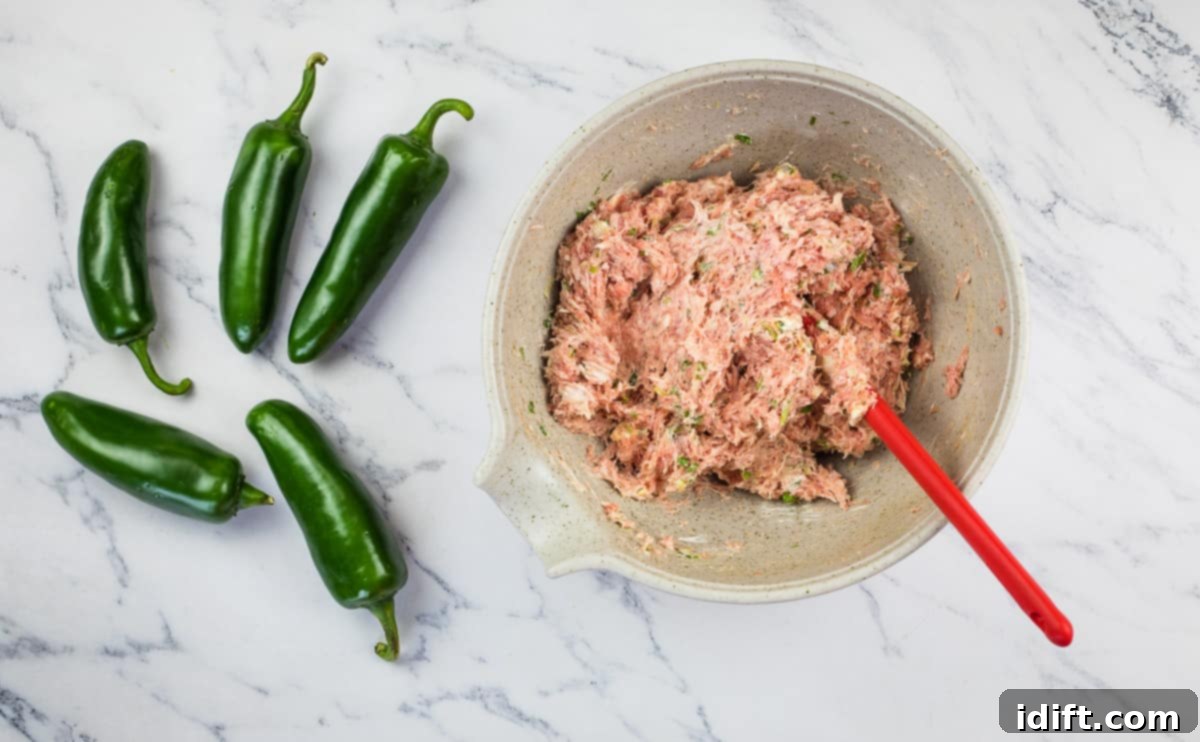 A close-up shot of the perfectly mixed pork and cream cheese filling in a bowl, showing its smooth and ready consistency.
