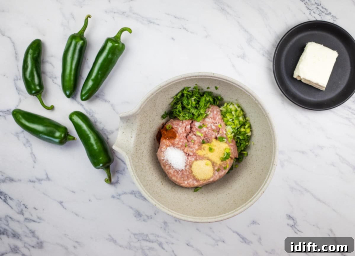 A bowl containing ground pork, softened cream cheese, and various spices, being mixed together to create the savory filling.