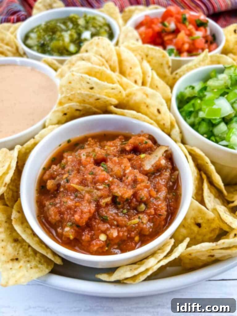 Food processor salsa on a board with other salsas and dips.