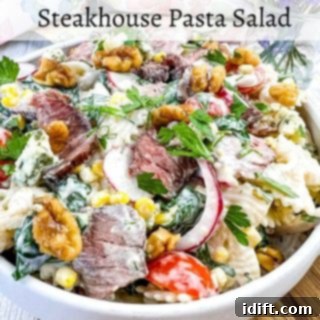 A closeup of Steakhouse Pasta Salad in a white bowl.