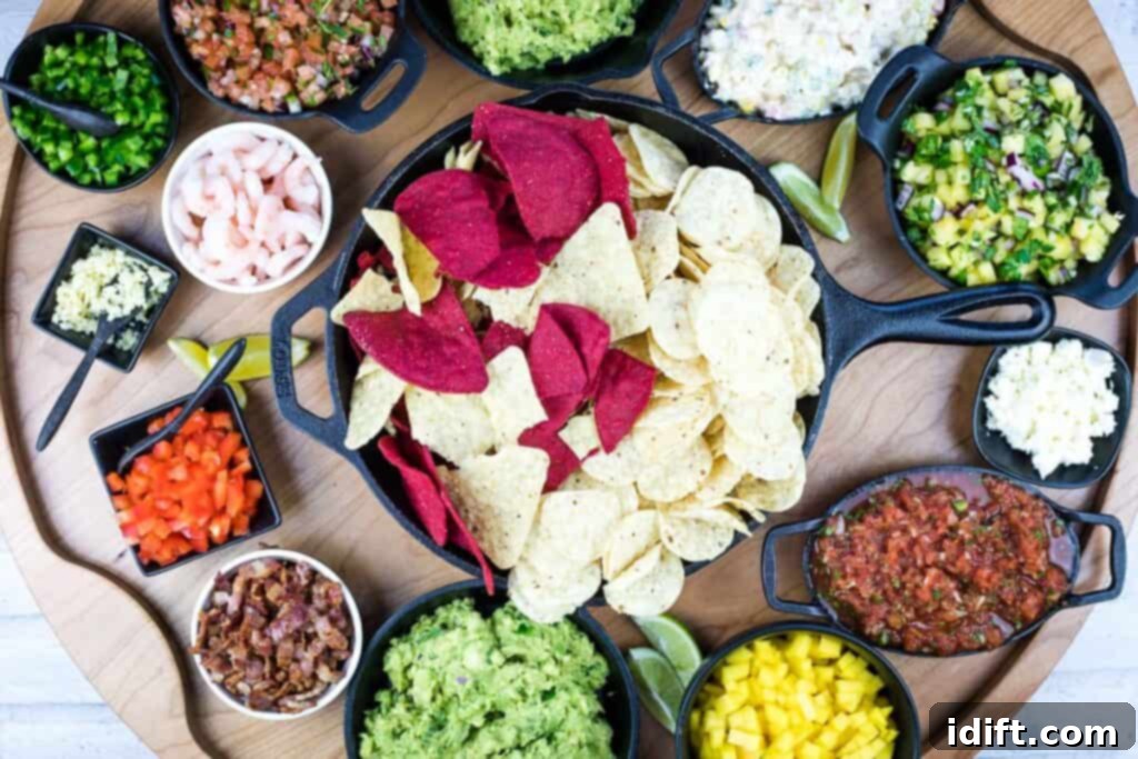 Finished guacamole snack board, showcasing a variety of dips, chips, and fresh ingredients.