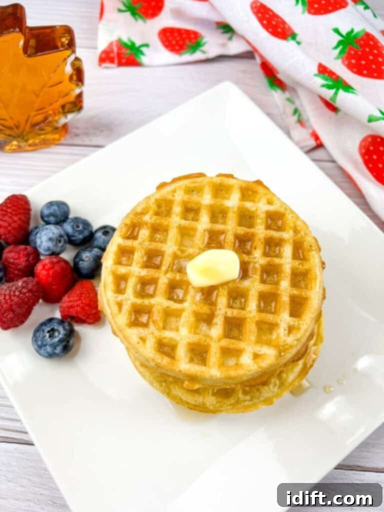 Air Fryer Frozen Waffles: The Ultimate Crisp 2 A stack of waffles heated up in the air fryer, topped with butter and syrup.