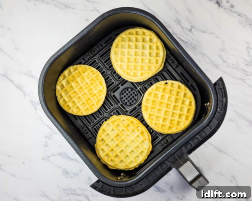 Air Fryer Frozen Waffles: The Ultimate Crisp 4 Frozen waffles placed in an air fryer basket, ready for cooking.