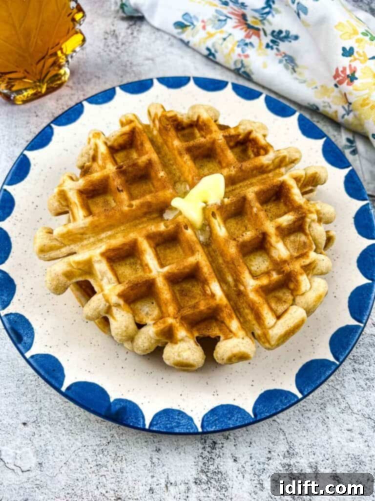 Air Fryer Frozen Waffles: The Ultimate Crisp 6 Air fryer frozen waffles reheated and on a plate topped with butter.