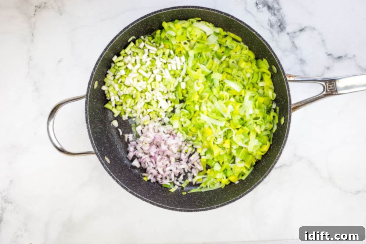 Sautéing the leeks, shallots, and green garlic.