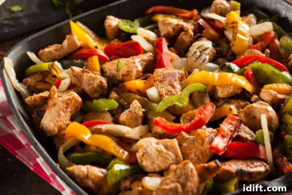 Next-Level Taco Bar Ideas for Your Tuesday Feast 4 Sizzling chicken fajitas served hot in a cast-iron skillet, surrounded by fresh tortillas and lime wedges.