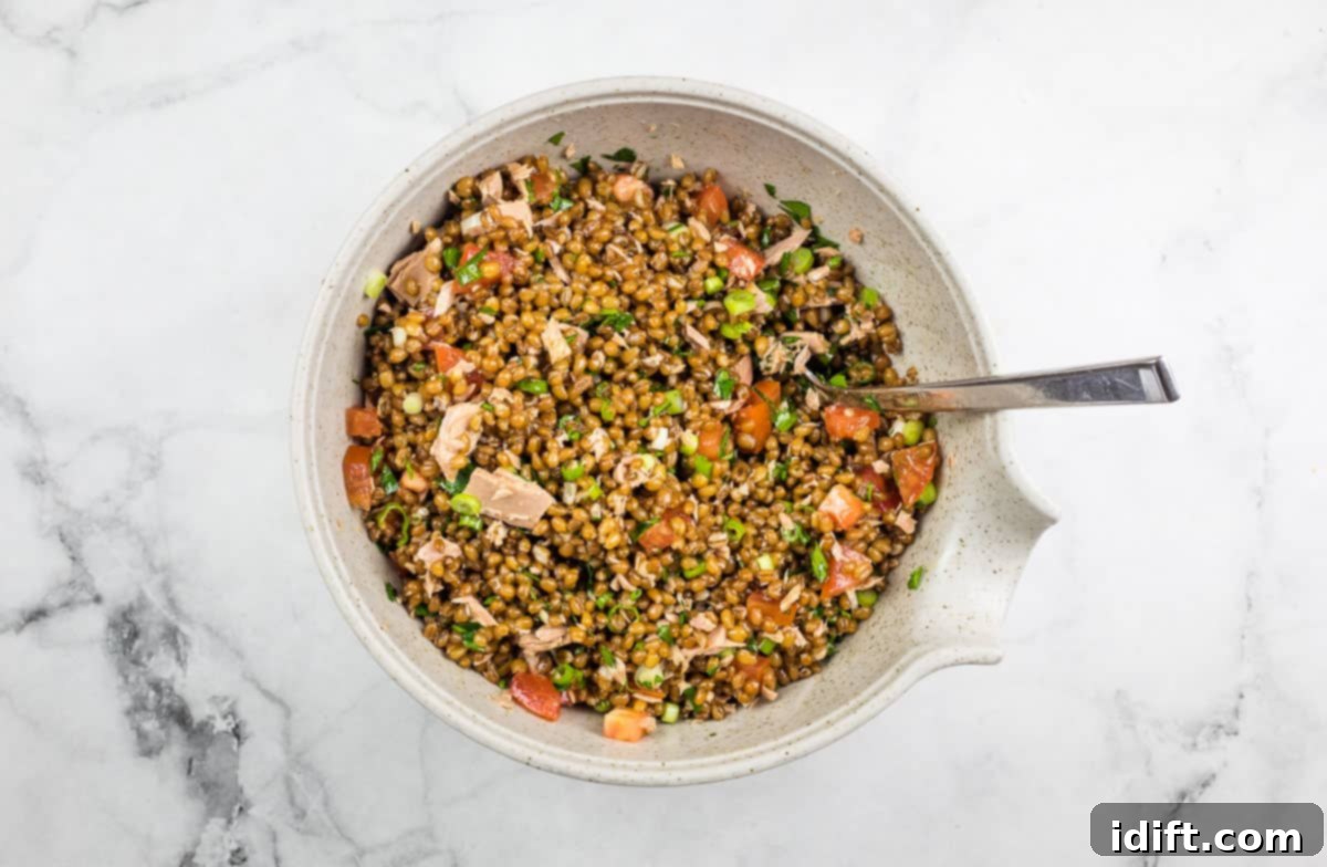 Mixed salad with dressing evenly distributed, showing vibrant colors and textures.