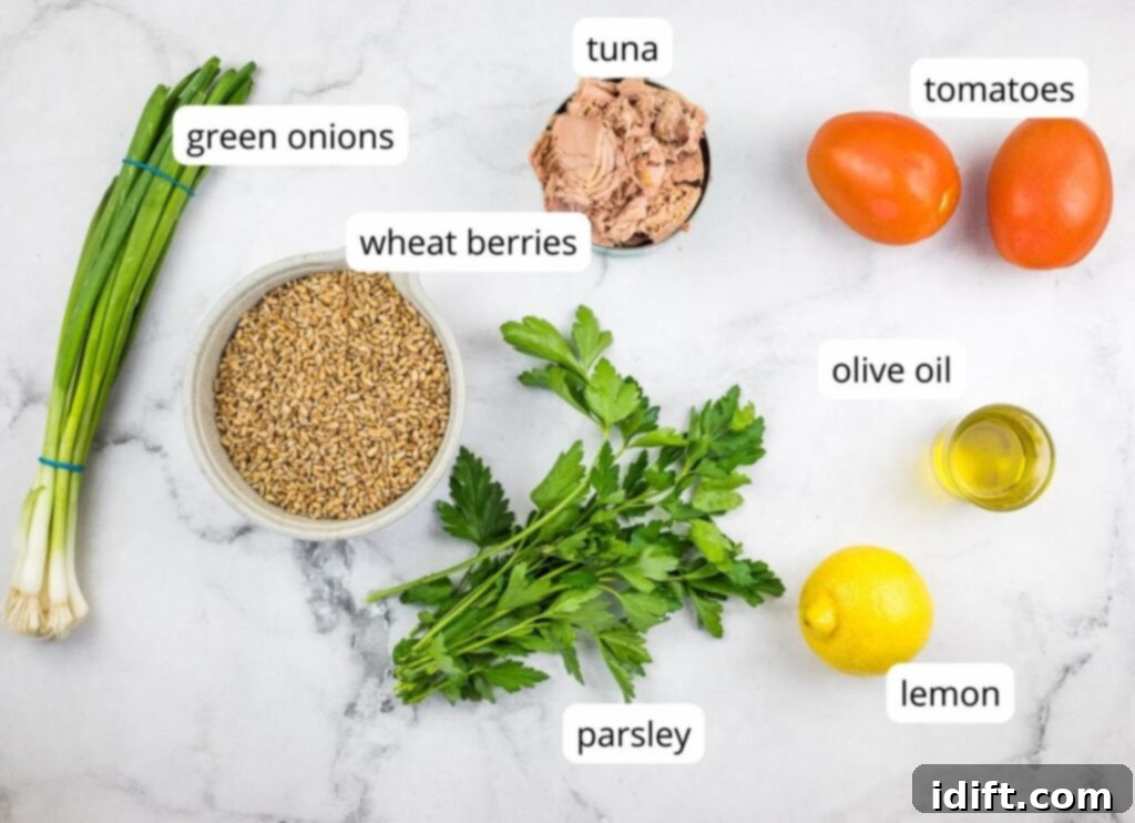 labeled ingredients to make Wheat Berry Salad with Tuna and Tomatoes, neatly arranged on a counter.
