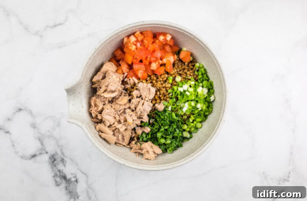 All salad components combined in a large mixing bowl before dressing.