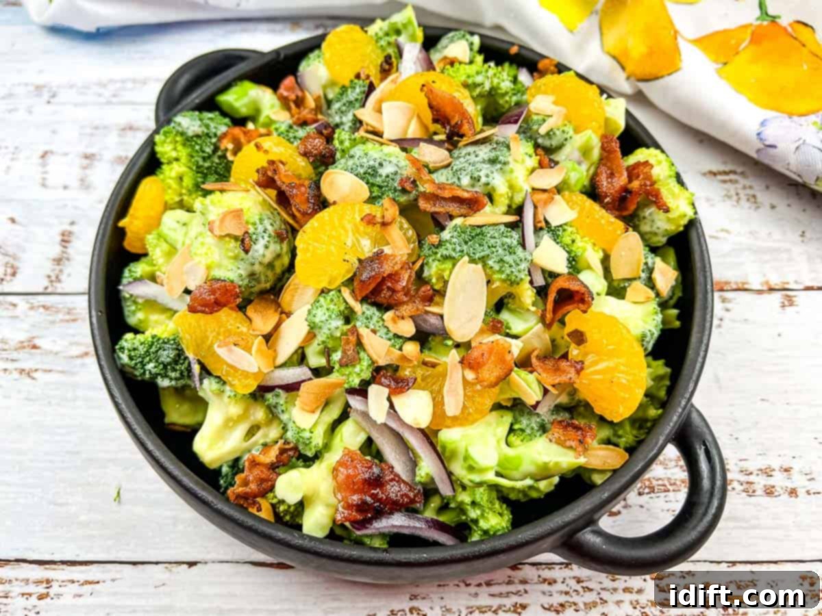 Vibrant Broccoli Salad with Zesty Orange and Smoky Bacon Crunch 9 The finished Broccoli Salad with Bacon and Almonds, garnished with crispy toppings, served attractively in a bowl.