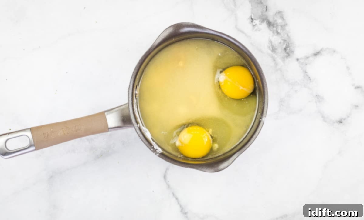 Vibrant Broccoli Salad with Zesty Orange and Smoky Bacon Crunch 6 Dressing ingredients, including eggs, sugar, vinegar, water, cornstarch, and mustard powder, combined in a small pot on the stovetop.