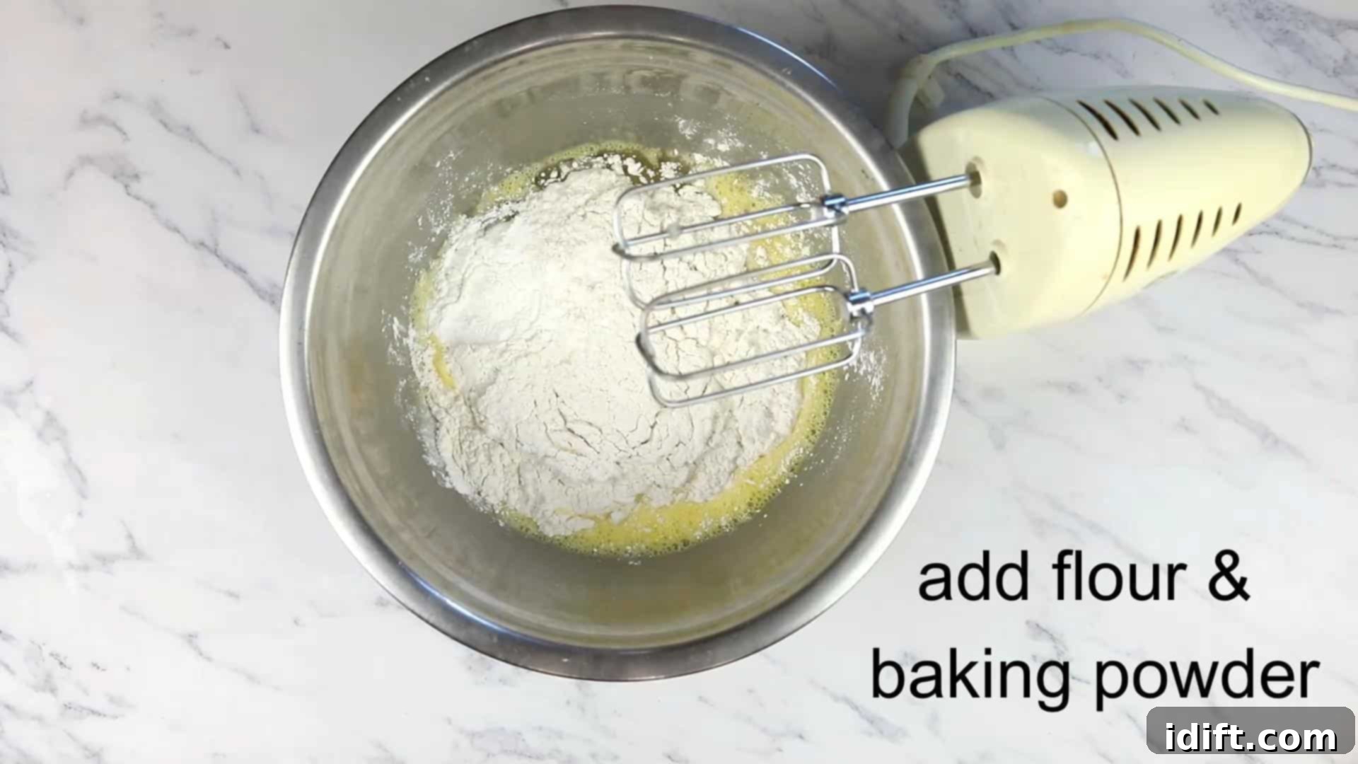 Savory Pizza Cups 8 Flour and baking powder being added to the whipped eggs and oil to form the muffin batter.