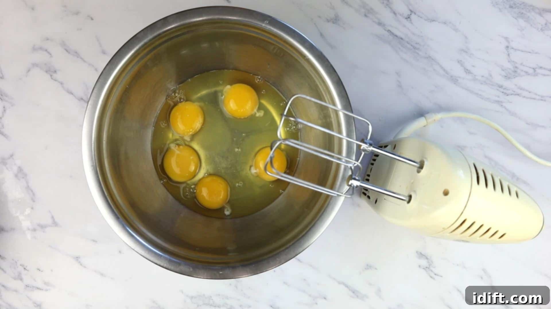 Savory Pizza Cups 7 Fresh eggs cracked into a bowl, ready to be whipped for the muffin batter.