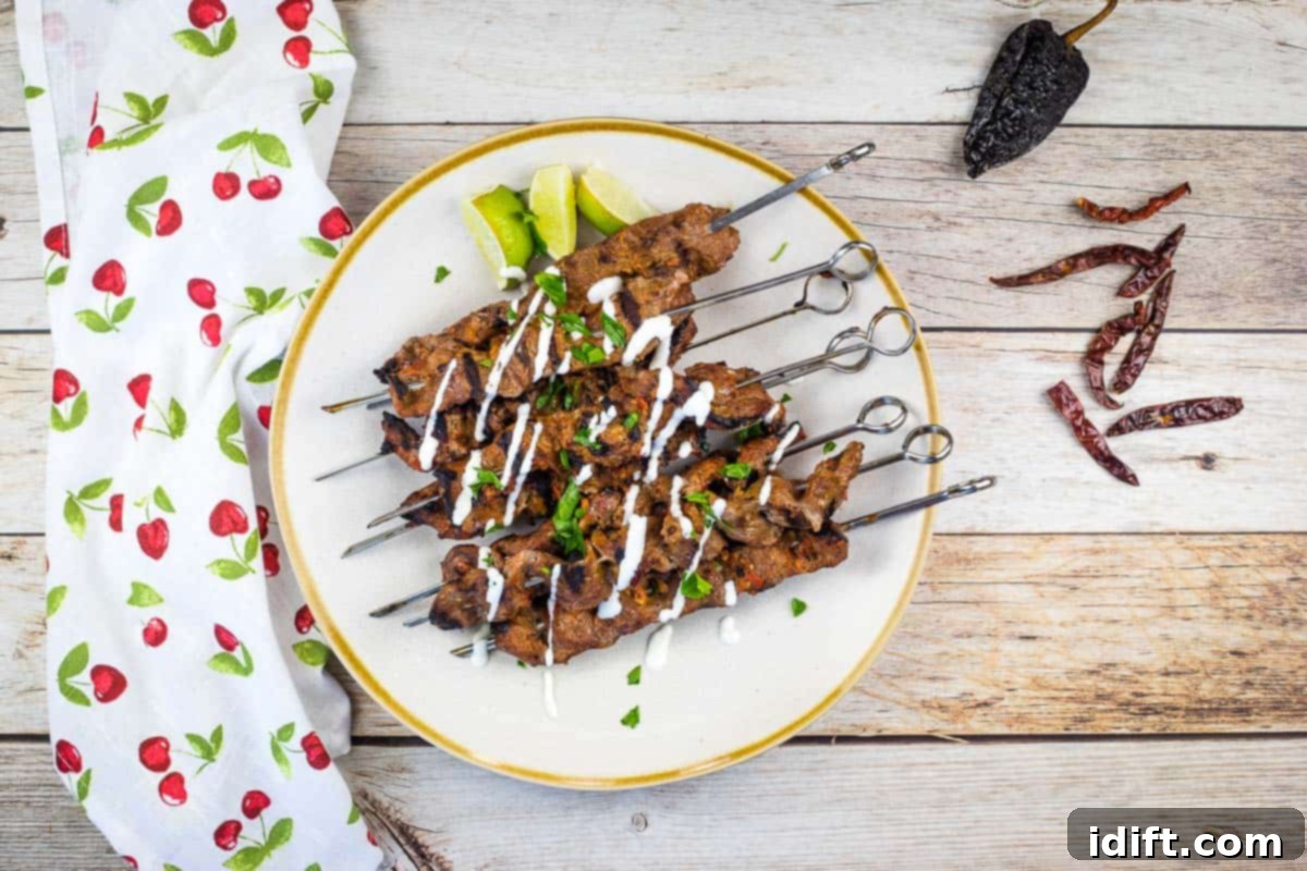 Sizzling Steak Skewers with Zesty Mojo Rojo 10 A plate featuring freshly cooked Grilled Steak Skewers with Mojo Rojo, garnished and ready to be enjoyed.