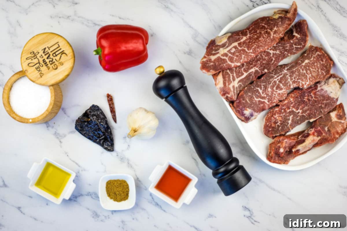 Sizzling Steak Skewers with Zesty Mojo Rojo 5 All ingredients neatly laid out: sirloin steak, dried ancho and arbol chiles, red bell pepper, garlic, cumin, red wine vinegar, and olive oil.