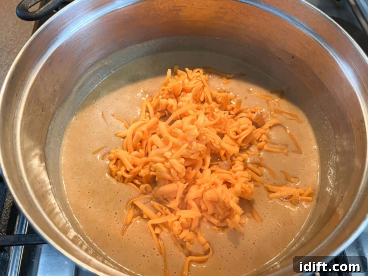 Hearty Guinness Beer Cheese Dip 8 Cheddar cheese added to the sauce.