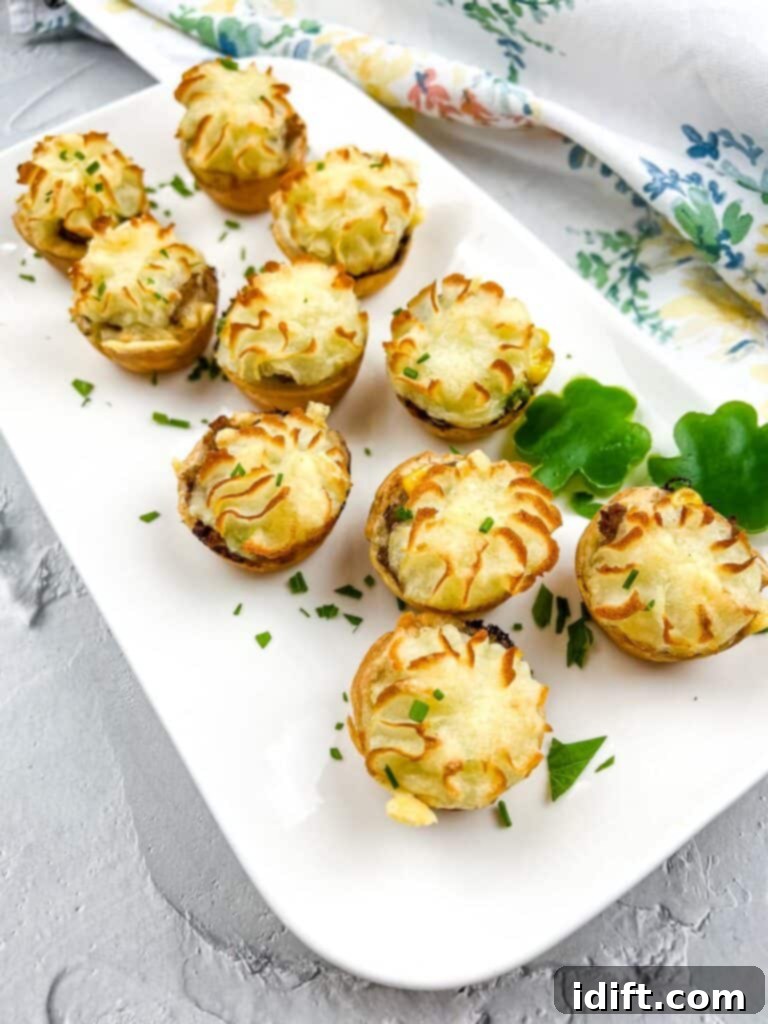 Shepherds Pie Poppers 2 Shepherd's Pie Bites on a white platter, showcasing their golden crust and potato topping.