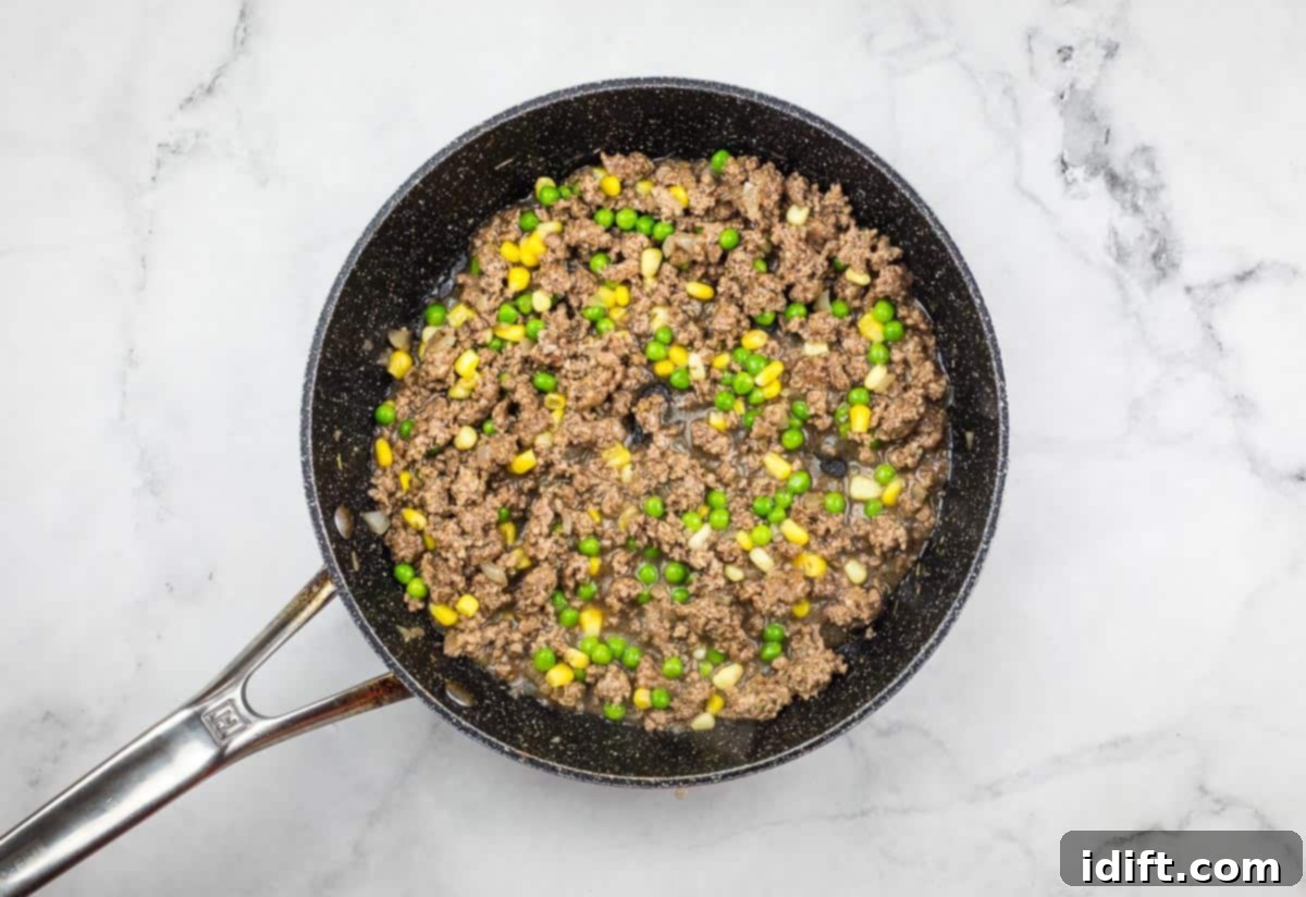 Shepherds Pie Poppers 8 Peas and corn added to the beef filling in a skillet.