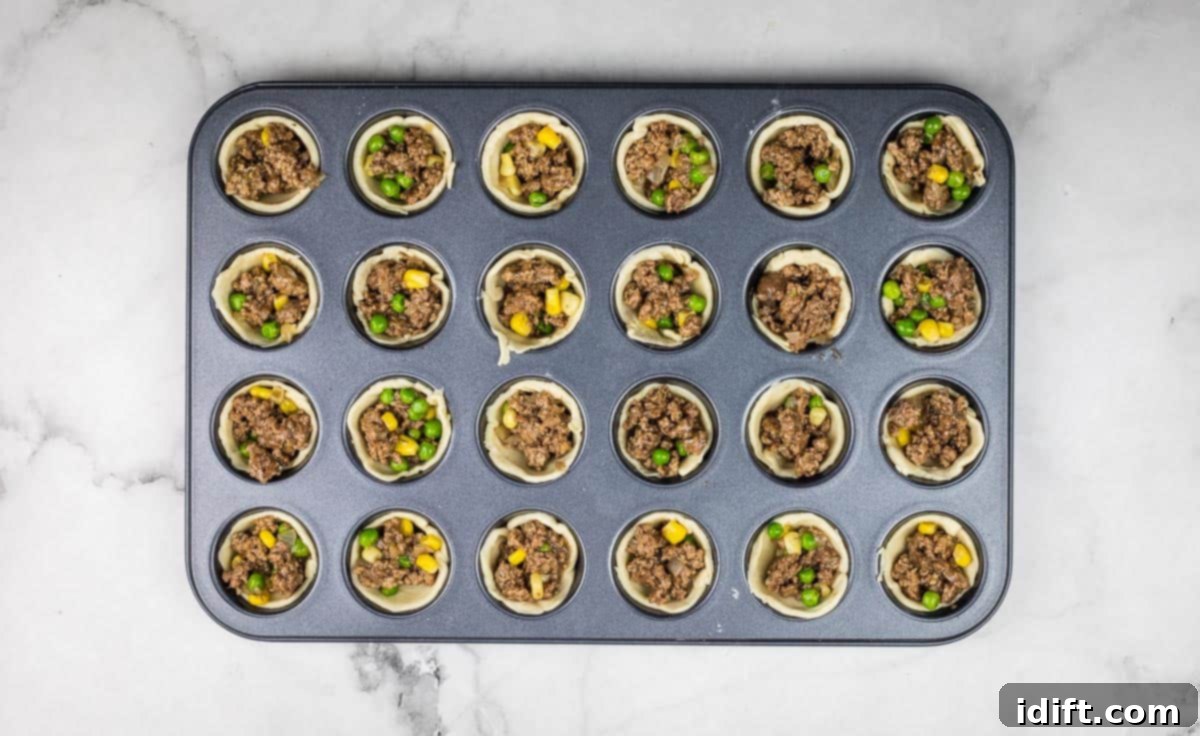 Shepherds Pie Poppers 11 Beef filling added to the mini muffin tin cups.