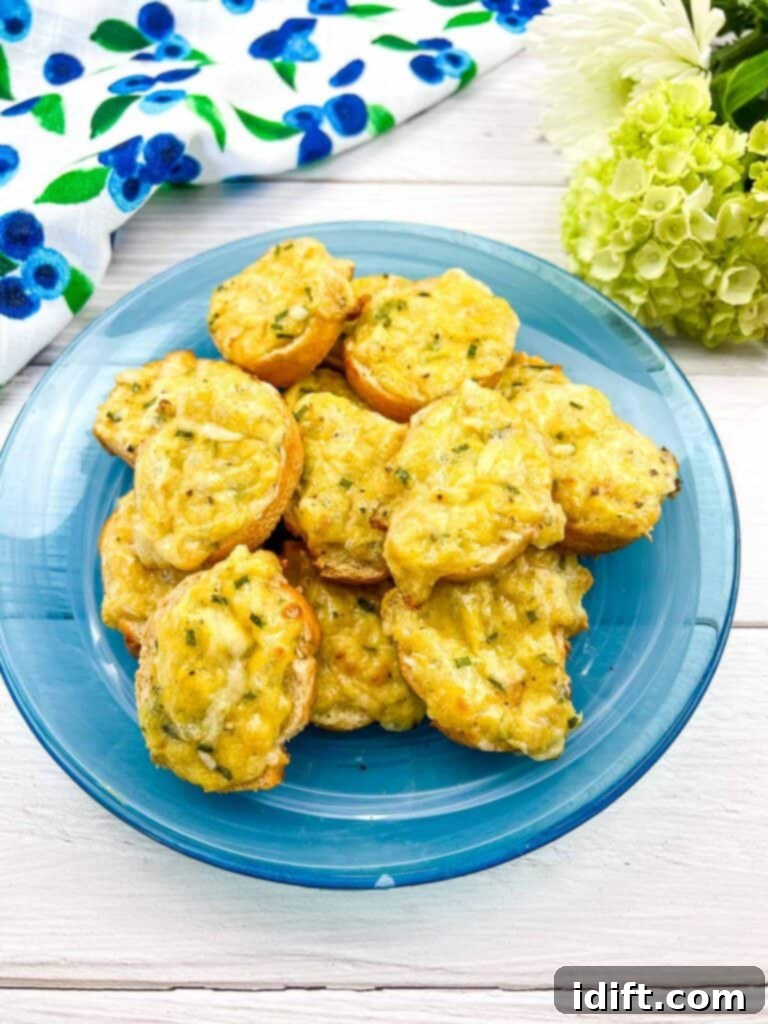 Golden-brown cheese toasties piled on a blue plate, ready to be served as an appetizer or snack.