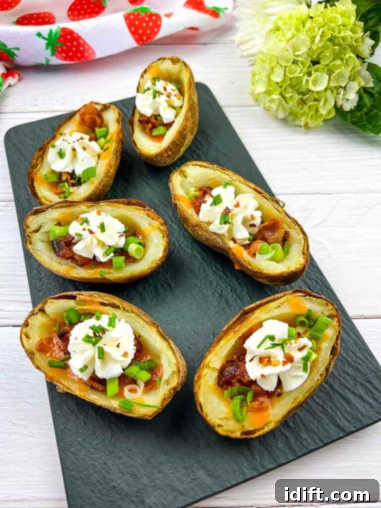 Fully loaded Baked Potato Skins on a black platter.