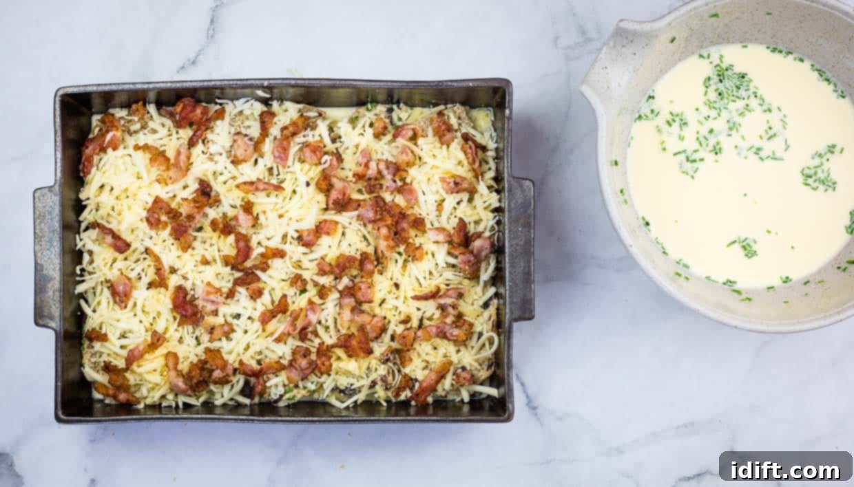 Spiced Hot Cross Bun French Toast Bake 9 Casserole topped with cheese and bacon.