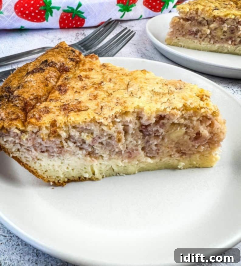 A slice of Ham and Cheese Impossible Quiche with a second slice in the background.