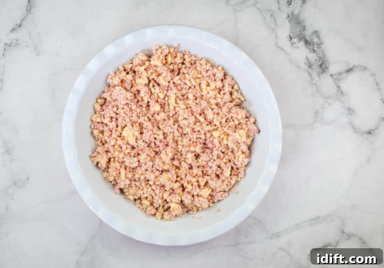 Ham and cheese mixture in a pie dish.