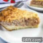 A slice of Ham and Cheese Impossible Quiche with a second slice in the background.