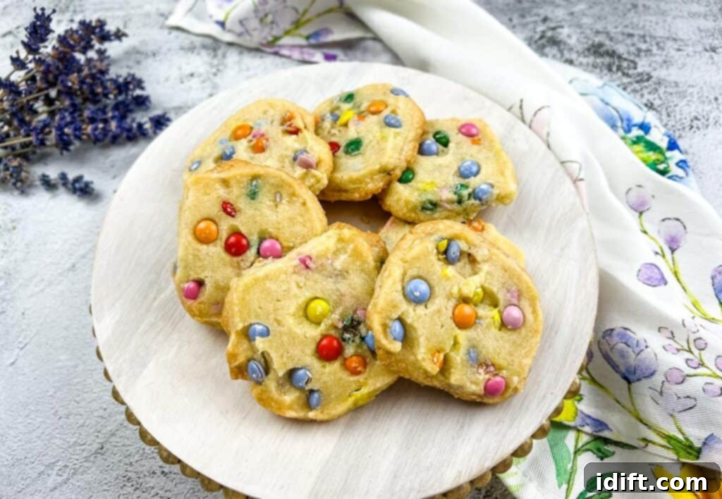 Spring Blossom Shortbread with Cheerful Candy Drops 3 A beautifully arranged plate of freshly baked Easter Shortbread cookies, highlighting their colorful M&Ms.