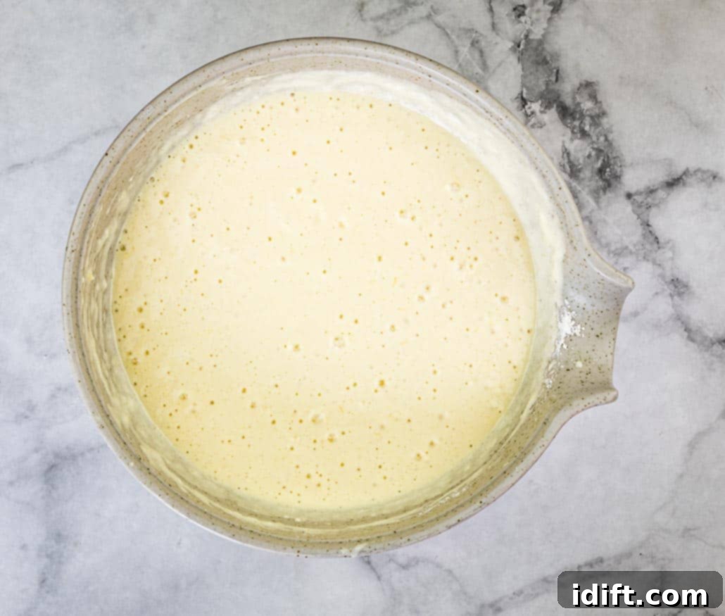 Sausage Pancake Poppers 10 Buttermilk pancake batter in a large bowl, showing a smooth but slightly lumpy consistency after mixing.