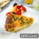 Impossible Broccoli Three-Cheese Quiche 13 A slice of broccoli & 3-cheese quiche on a plate with fruit.