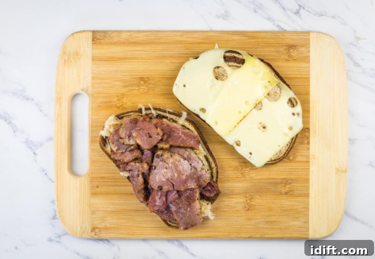 Sliced cheese on one half, meat on the other half of the sandwich.