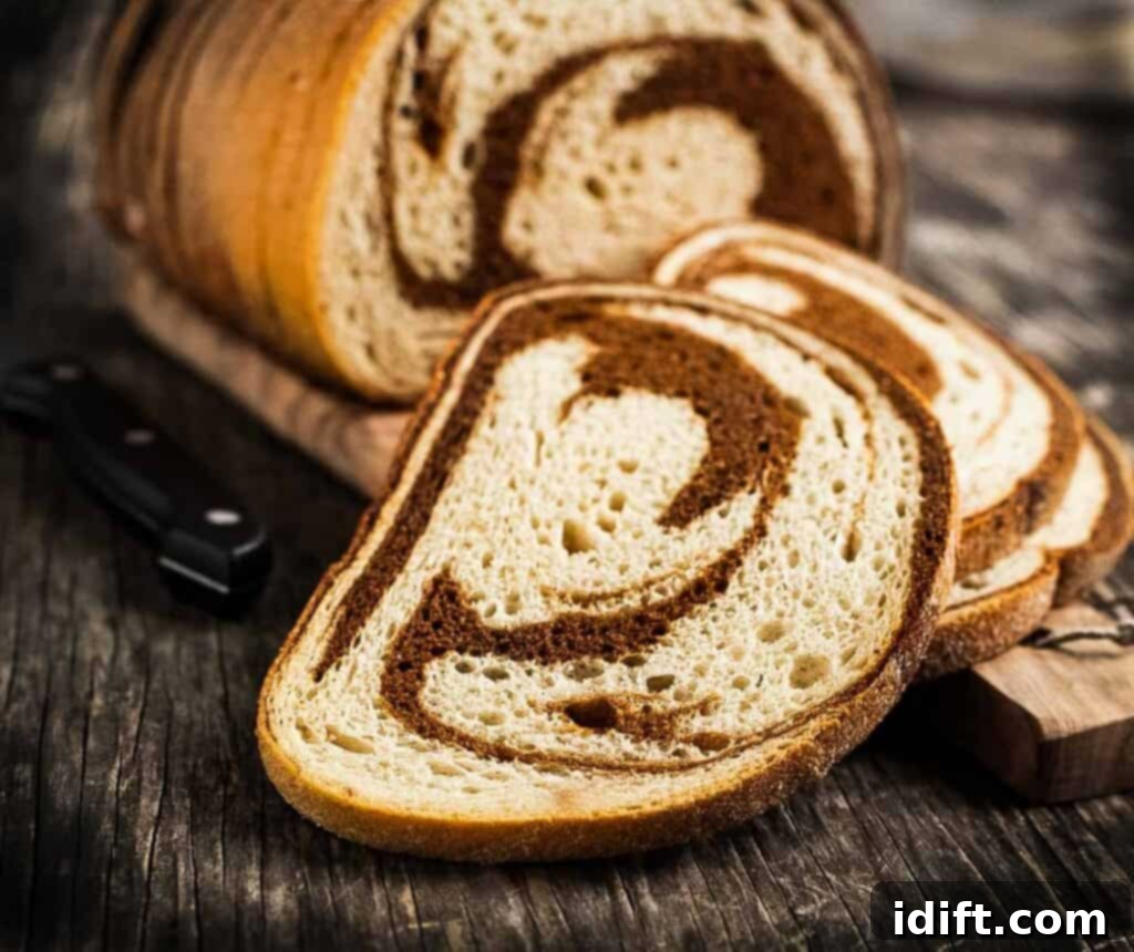 Sliced marble rye bread on a cutting board.