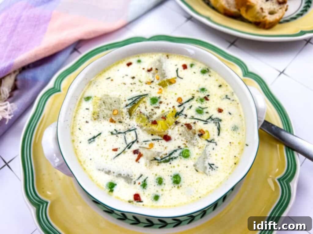 Potato and Green Pea Chowder 5 A single elegant bowl of Creamy Potato & Pea Chowder, showcasing its rich texture and vibrant green peas.