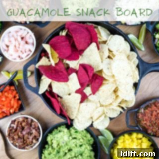 A top-down shot of a vibrant guacamole snack board, surrounded by fresh vegetables and chips.