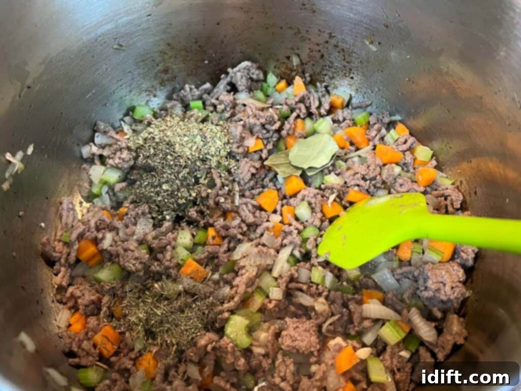 Adding dried spices like oregano, basil, and thyme to the sautéed vegetables in a pot.