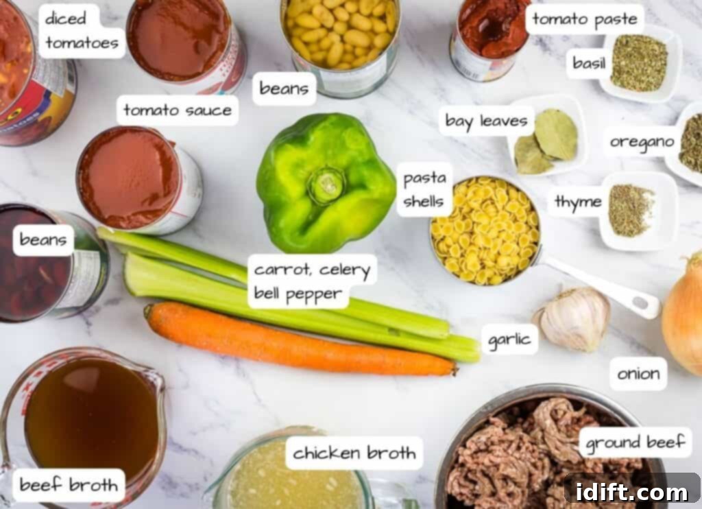 Neatly arranged fresh and canned ingredients for Pasta e Fagioli Soup on a wooden surface.