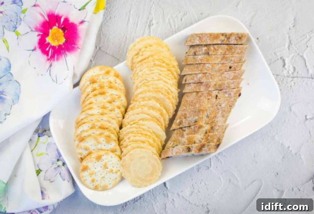 An array of fresh baguettes and various crackers perfectly arranged for a charcuterie board.
