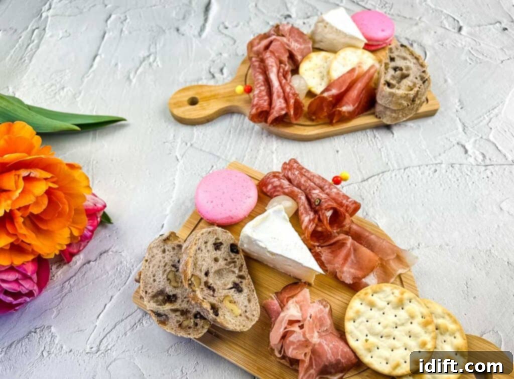 Multiple charming individual charcuterie boards, each adorned with small floral arrangements, perfect for Mother's Day.