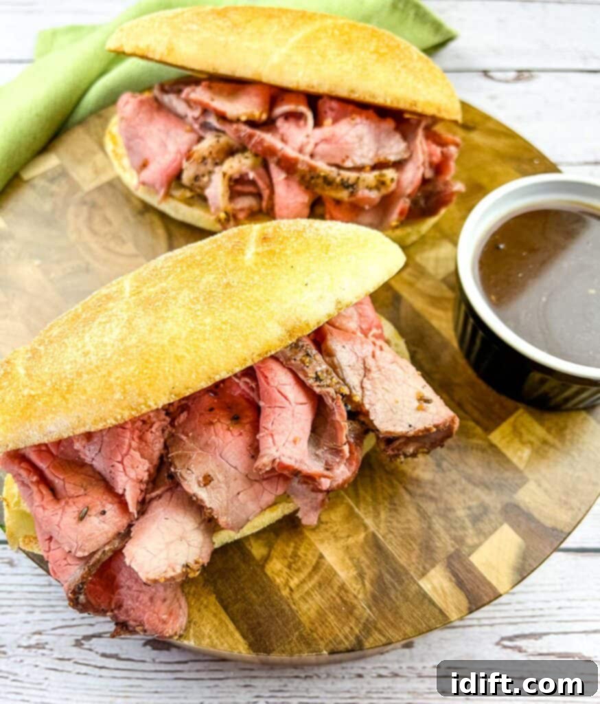 Smoked French Dip Sandwiches with jus on the side.