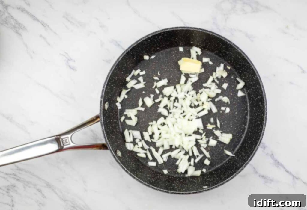 Hearty Corned Beef Hash Bake 8 Diced onions sautéing in butter in a hot skillet until translucent.