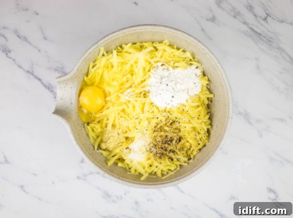 Hearty Corned Beef Hash Bake 10 Thawed shredded potatoes, egg, flour, and Dijon mustard mixed in a large bowl.