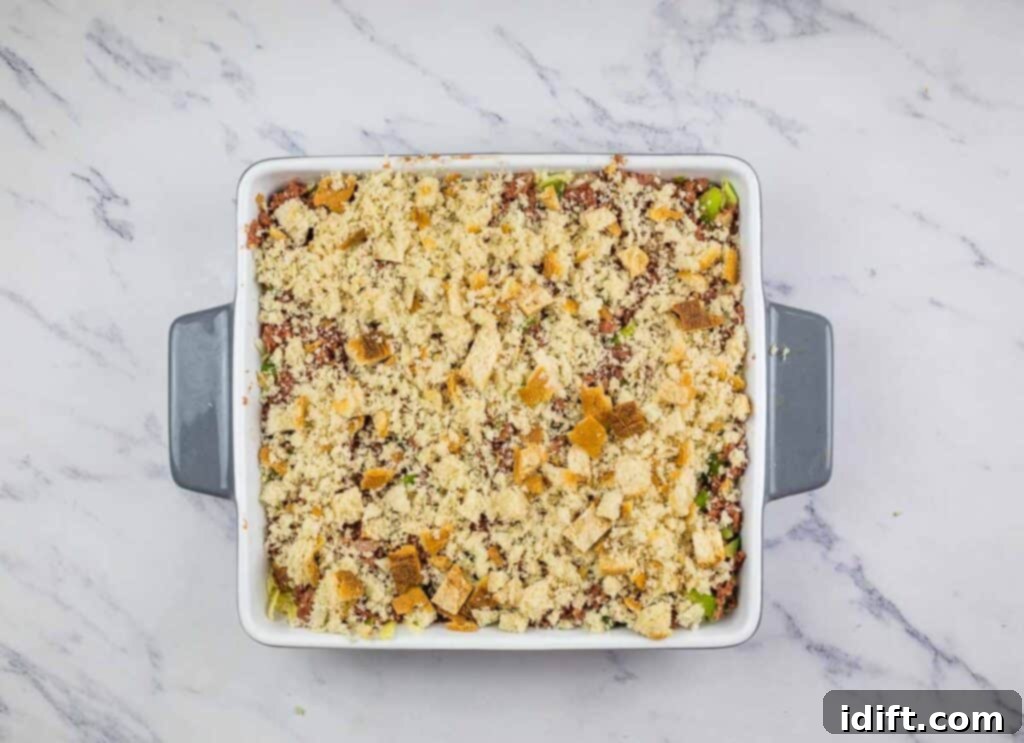 The casserole topped with buttered rye bread crumbs, ready for baking.