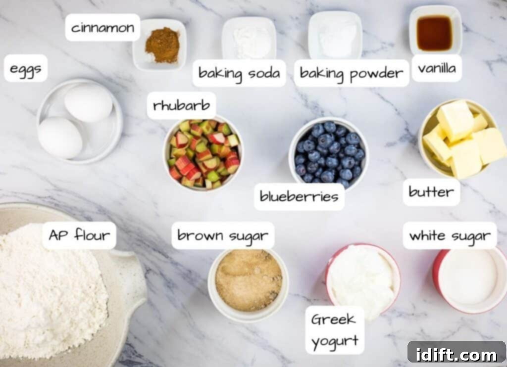 Vibrant Blueberry Rhubarb Muffins 4 Collection of labeled ingredients for blueberry rhubarb muffins, including sugars, butter, eggs, yogurt, vanilla, flour, leavening, salt, blueberries, and diced rhubarb.