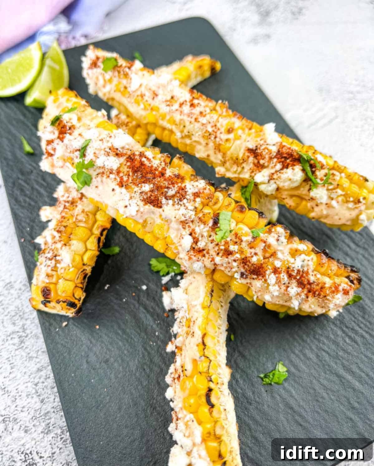 Grilled Elote Corn Ribs on a black plate, beautifully garnished and ready to serve.